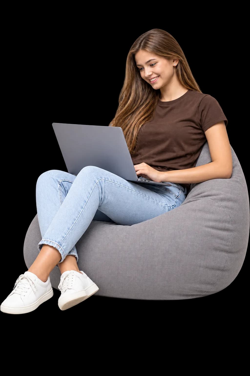 A Corevia client working on a laptop from a bean bag chair